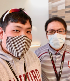 Two people wearing masks